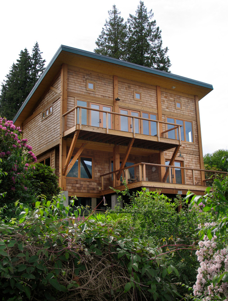 This is an example of a mid-sized transitional two-storey beige house exterior in Seattle with wood siding.