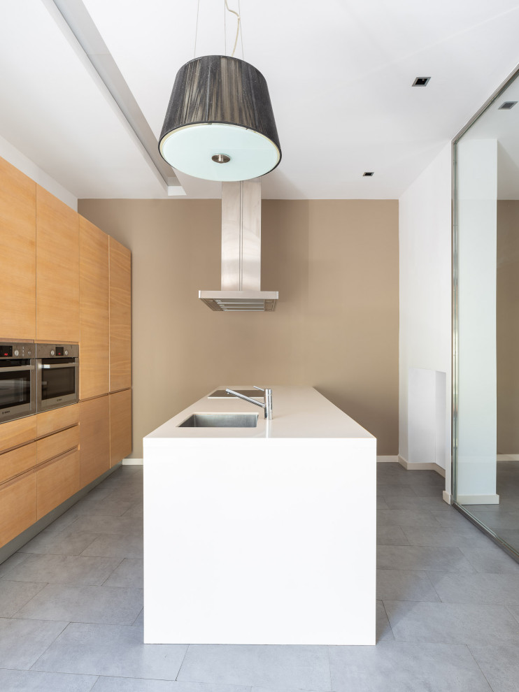 Design ideas for a contemporary single-wall open plan kitchen in Other with an integrated sink, flat-panel cabinets, medium wood cabinets, quartz benchtops, white splashback, metal splashback, stainless steel appliances, ceramic floors, with island, grey floor and white benchtop.