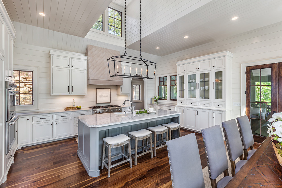 Design ideas for a beach style eat-in kitchen in Other with an undermount sink, shaker cabinets, white cabinets, stainless steel appliances, dark hardwood floors and with island.