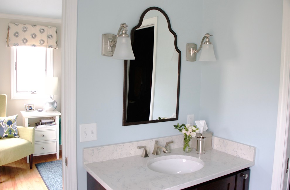 Small transitional master white tile and ceramic tile ceramic tile corner shower photo with shaker cabinets, dark wood cabinets, a two-piece toilet, blue walls, an undermount sink and quartz countertops