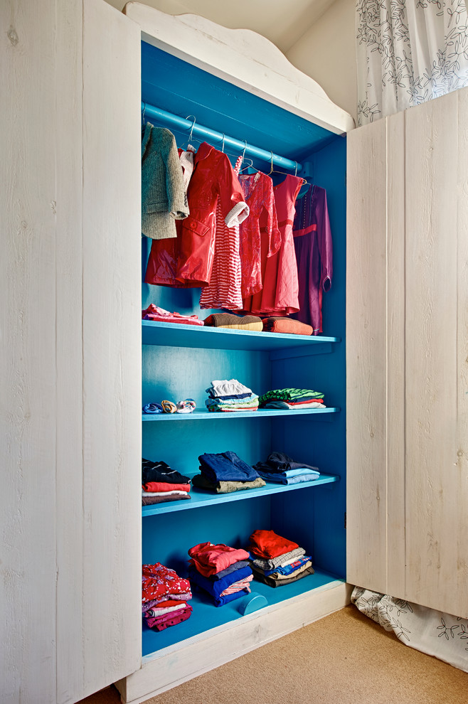 Inspiration for a small contemporary storage and wardrobe in London with carpet.
