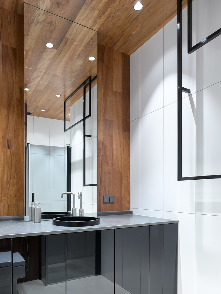 This is an example of a mid-sized contemporary 3/4 bathroom in Moscow with flat-panel cabinets, black cabinets, an alcove shower, white tile, porcelain tile, a drop-in sink, granite benchtops, a hinged shower door and grey benchtops.