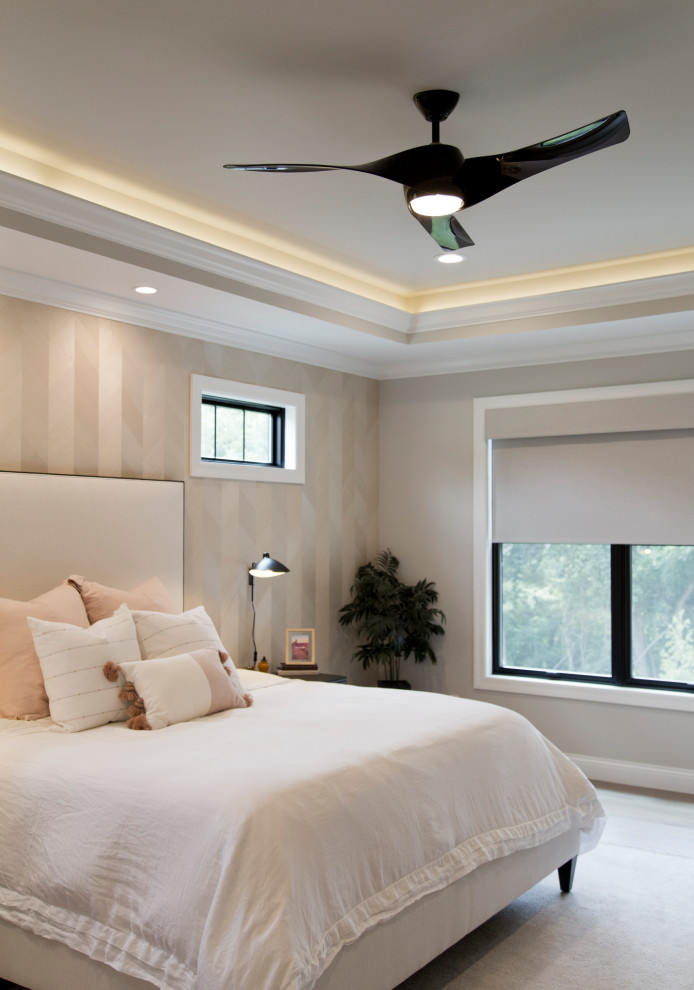 Inspiration for a large transitional master bedroom in St Louis with beige walls, light hardwood floors, beige floor, recessed and wallpaper.