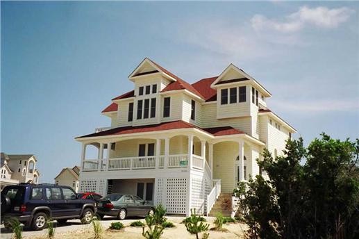 Inspiration for a large beach style two-storey yellow exterior in New York with wood siding and a gable roof.