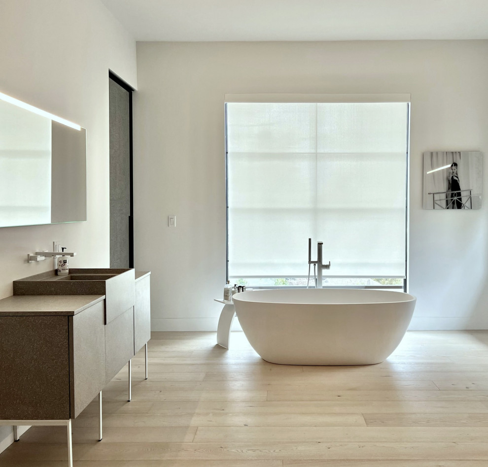 Photo of a contemporary ensuite bathroom in New York with flat-panel cabinets and a built in vanity unit.