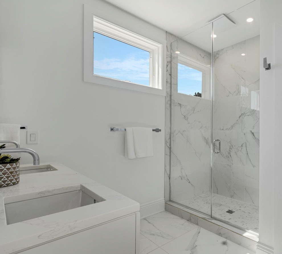 Doorless shower - mid-sized transitional master white tile and porcelain tile porcelain tile, white floor and double-sink doorless shower idea in DC Metro with a one-piece toilet, white walls, an undermount sink, quartz countertops, a hinged shower door, white countertops and a freestanding vanity