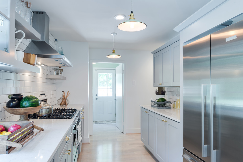 Design ideas for a large transitional galley eat-in kitchen in Portland Maine with an undermount sink, shaker cabinets, grey cabinets, quartz benchtops, white splashback, subway tile splashback, stainless steel appliances, light hardwood floors, no island and beige floor.