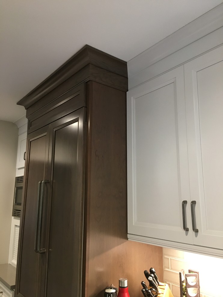 Large transitional u-shaped dark wood floor and brown floor open concept kitchen photo in Chicago with an undermount sink, flat-panel cabinets, white cabinets, quartz countertops, gray backsplash, ceramic backsplash, stainless steel appliances, an island and gray countertops