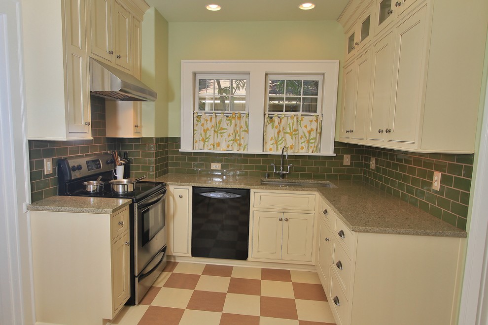 Small arts and crafts u-shaped separate kitchen in Other with a single-bowl sink, beaded inset cabinets, white cabinets, green splashback, stainless steel appliances, linoleum floors, no island and recycled glass benchtops.