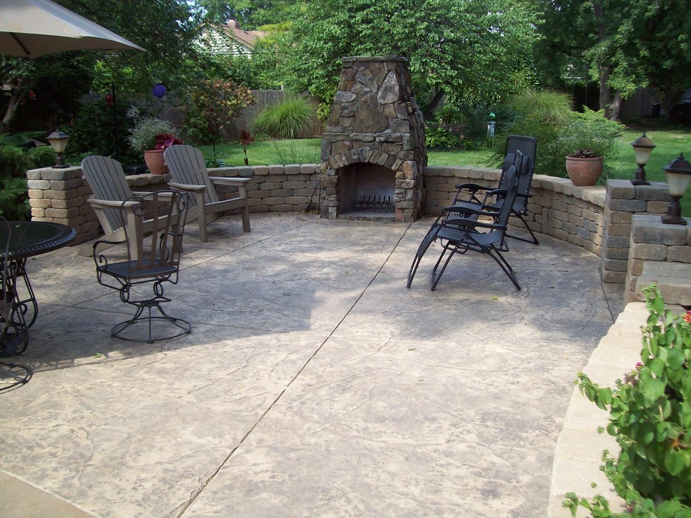 Photo of a country patio in Burlington with a fire feature, stamped concrete and no cover.