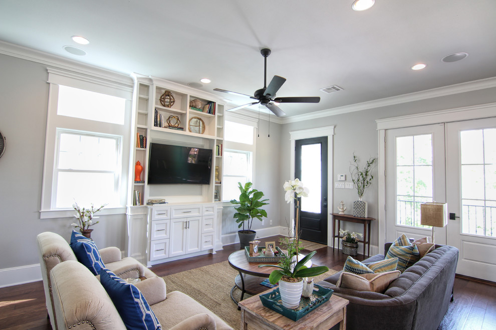Inspiration for a mid-sized beach style open concept family room in Houston with grey walls, a built-in media wall and dark hardwood floors.