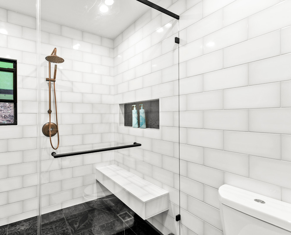 This is an example of a large transitional master bathroom in Los Angeles with shaker cabinets, white cabinets, white tile, subway tile, white walls, porcelain floors, black floor and white benchtops.
