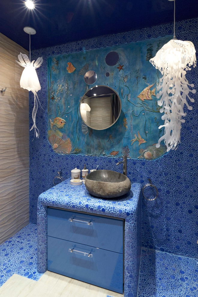 Inspiration for a large beach style master bathroom in Moscow with flat-panel cabinets, blue cabinets, a hot tub, a shower/bathtub combo, a wall-mount toilet, blue tile, mosaic tile, blue walls, ceramic floors, a vessel sink and tile benchtops.