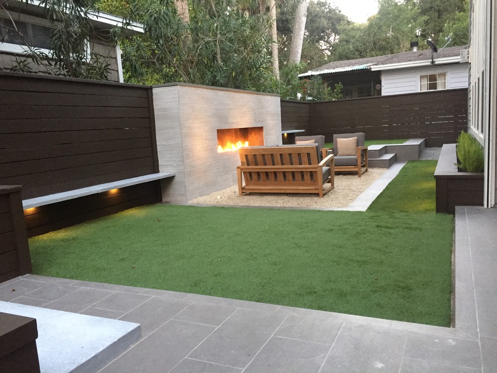 Design ideas for a small contemporary backyard patio in Jacksonville with tile, no cover and a fire feature.