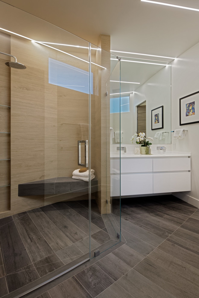 Design ideas for a large modern 3/4 bathroom in San Francisco with flat-panel cabinets, white cabinets, a curbless shower, a one-piece toilet, beige tile, white walls, an undermount sink, solid surface benchtops, grey floor, white benchtops, wood-look tile, a hinged shower door, a double vanity, a floating vanity, wood-look tile and a niche.