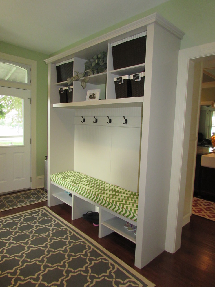 Design ideas for a mid-sized transitional mudroom in Other with green walls and medium hardwood floors.