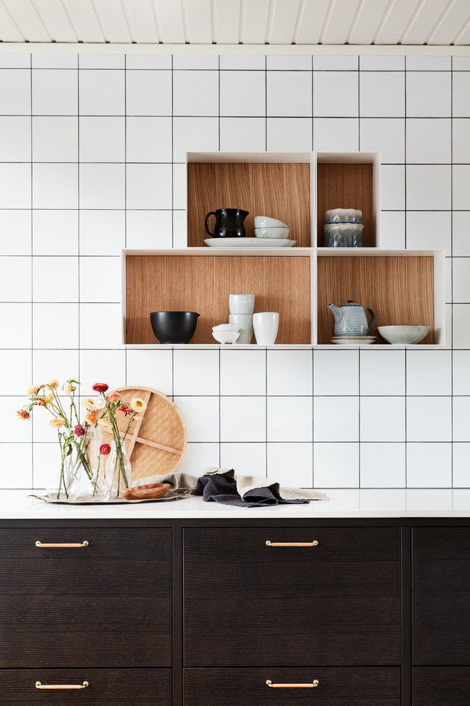 Inspiration for a mid-sized contemporary single-wall eat-in kitchen in Malmo with an undermount sink, flat-panel cabinets, brown cabinets, laminate benchtops, white splashback, porcelain splashback and black appliances.