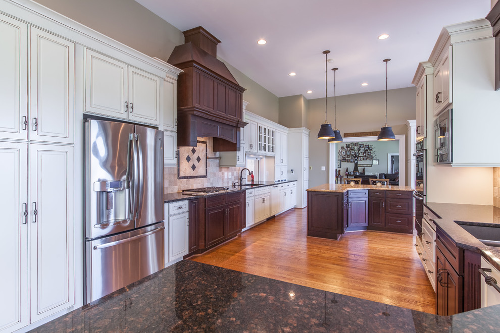 Huge transitional medium tone wood floor eat-in kitchen photo in DC Metro with raised-panel cabinets, granite countertops, stainless steel appliances and an island