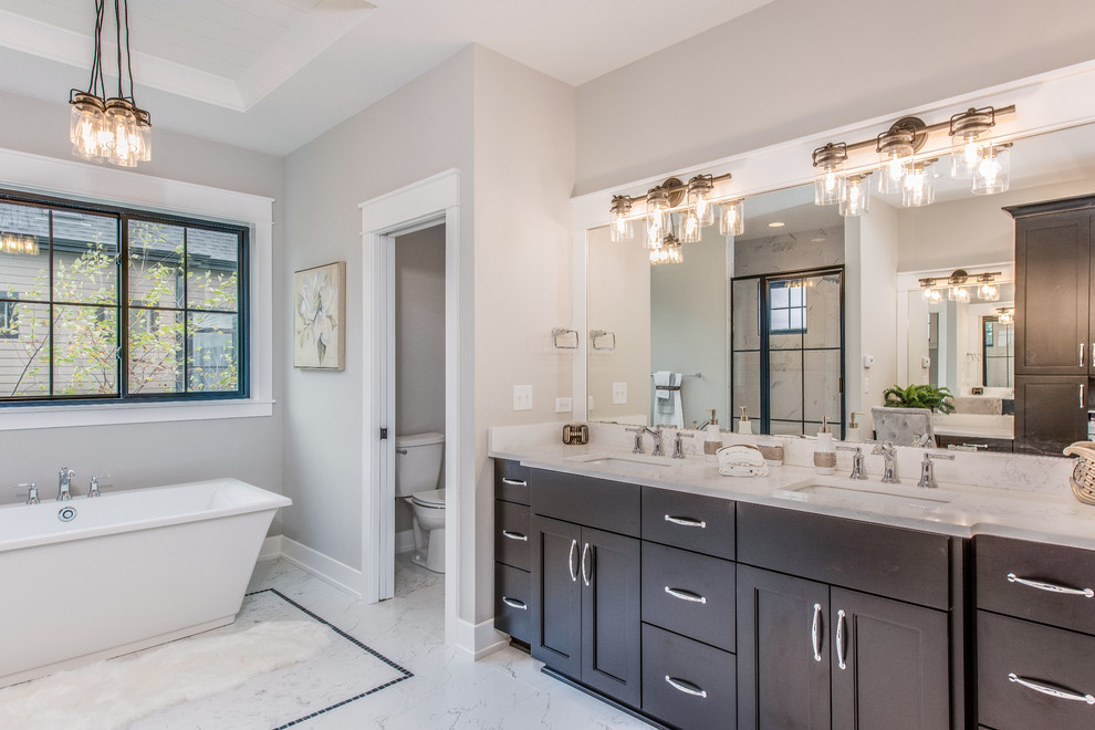 Country bathroom in Chicago with shaker cabinets, dark wood cabinets, a freestanding tub, grey walls, an undermount sink, white floor and white benchtops.