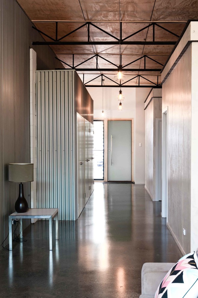 Design ideas for a mid-sized industrial hallway in Gold Coast - Tweed with concrete floors.