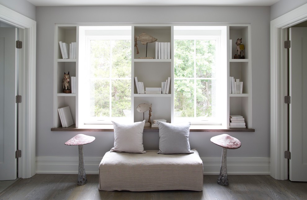 This is an example of a transitional gender-neutral kids' room in New York with grey walls and dark hardwood floors.
