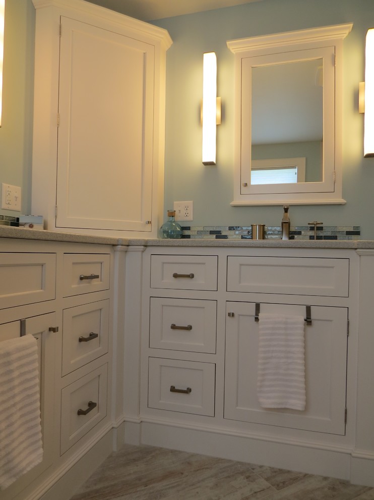 Mid-sized beach style master bathroom in Portland Maine with an undermount sink, beaded inset cabinets, white cabinets, engineered quartz benchtops, a curbless shower, a two-piece toilet, multi-coloured tile, glass tile, blue walls and porcelain floors.