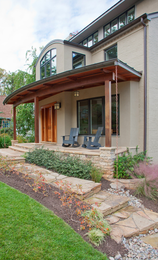 Design ideas for a transitional verandah in DC Metro with natural stone pavers and a roof extension.