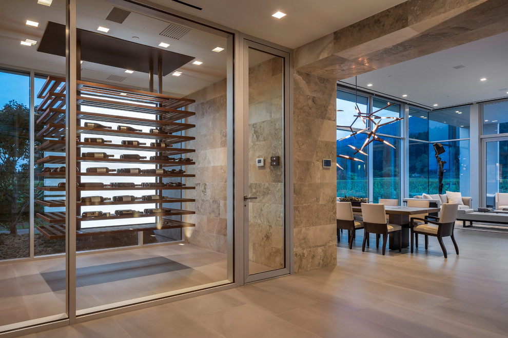 Photo of a contemporary wine cellar in Other with display racks and beige floor.