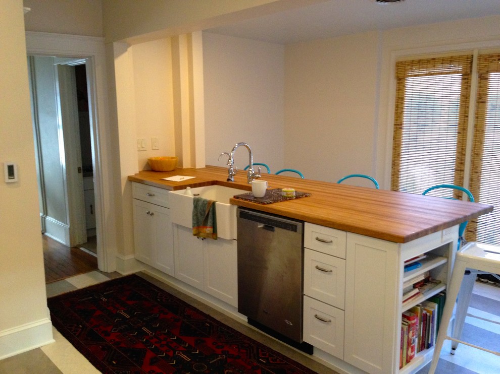 Example of a large transitional cork floor kitchen design in Baltimore with a farmhouse sink, flat-panel cabinets, white cabinets, wood countertops, stainless steel appliances and a peninsula