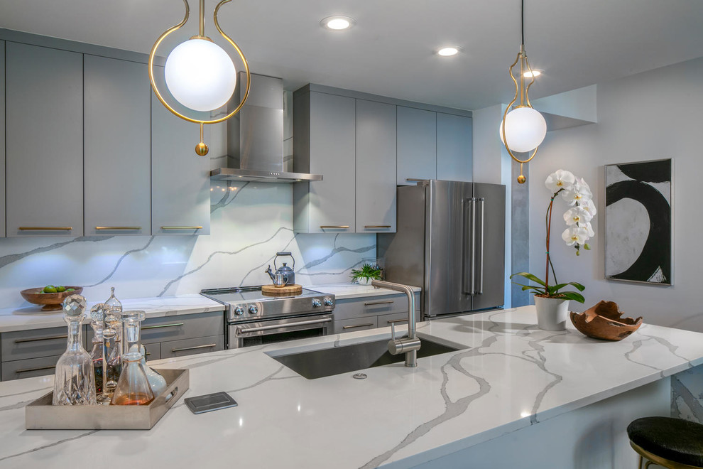 Inspiration for a mid-sized modern galley kitchen in Tampa with an undermount sink, flat-panel cabinets, grey cabinets, quartz benchtops and with island.