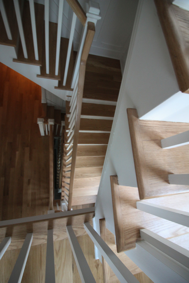Design ideas for a large traditional wood l-shaped staircase in DC Metro with wood risers and wood railing.