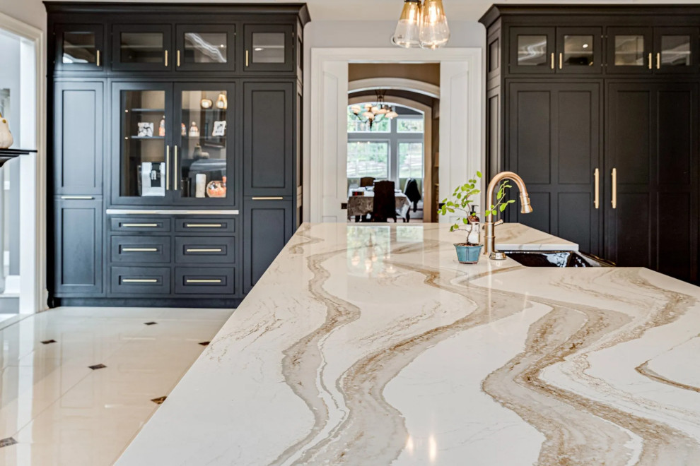 Kitchen - transitional beige floor kitchen idea in Baltimore with black cabinets, beige backsplash, an island and beige countertops