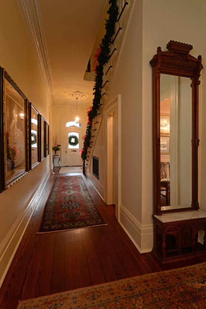Inspiration for a large traditional hallway in New Orleans with white walls and dark hardwood floors.