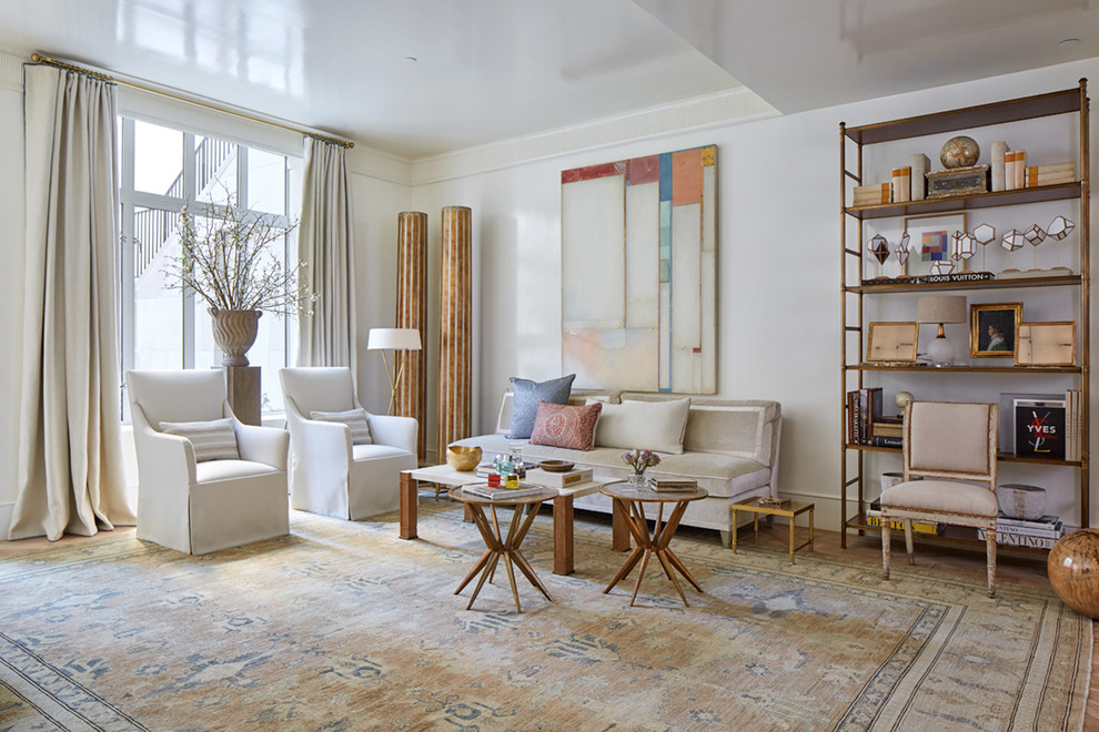 Design ideas for a transitional living room in New York with white walls, medium hardwood floors and brown floor.