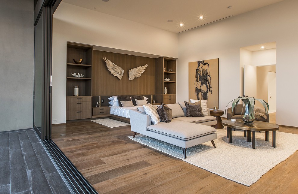 Bedroom - huge contemporary master medium tone wood floor and brown floor bedroom idea in Las Vegas with white walls