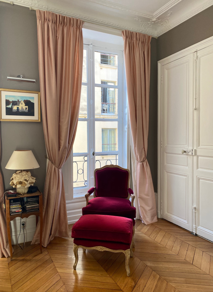 Inspiration for a medium sized traditional enclosed living room in Paris with grey walls, light hardwood flooring, brown floors and no fireplace.