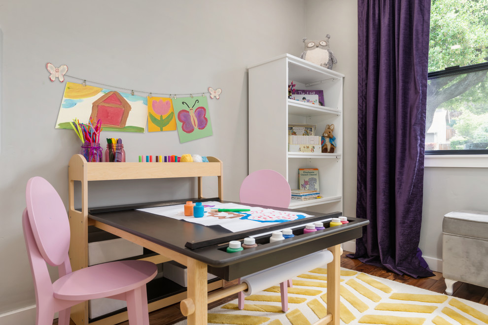 Edgewood - Fairy Tail Bedrooms - Fun, royal-themed girl's bedroom featuring loft bed with secret reading nook, art station, dress-up mirror, golden rug, custom purple drapes, and purple and gray walls. Photo by Exceptional Frames.