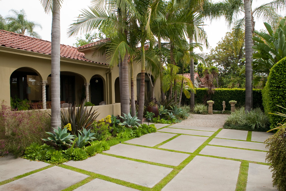 Mid-sized mediterranean front yard partial sun garden in Los Angeles with concrete pavers.