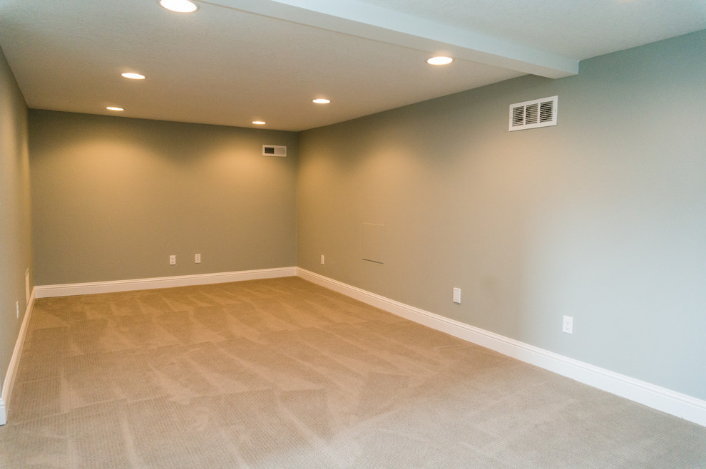 Photo of a large arts and crafts look-out basement in Portland with beige walls, carpet and no fireplace.