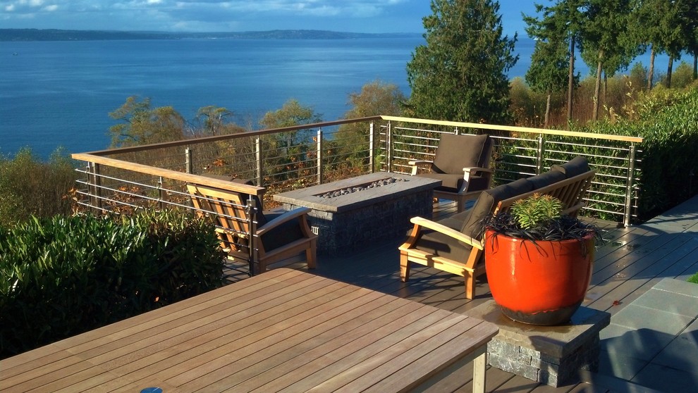 Mid-sized contemporary backyard patio in Seattle with a fire feature, decking and no cover.
