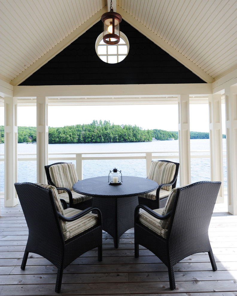 Inspiration for a mid-sized beach style backyard deck in Other with a roof extension.