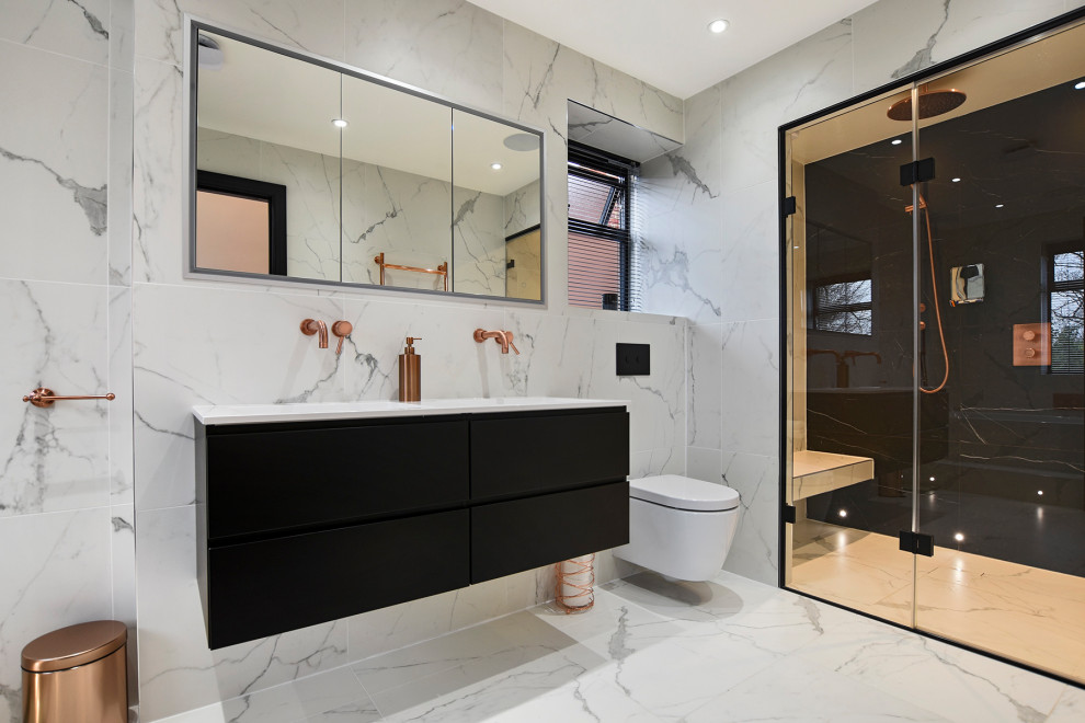 Design ideas for a large contemporary master bathroom in London with flat-panel cabinets, black cabinets, an alcove shower, a wall-mount toilet, gray tile, an undermount sink, grey floor, a hinged shower door, white benchtops, a double vanity and a floating vanity.