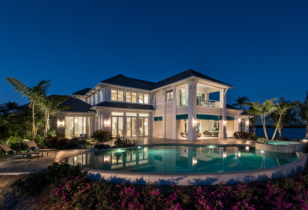Inspiration for a large transitional backyard tile and custom-shaped natural pool remodel