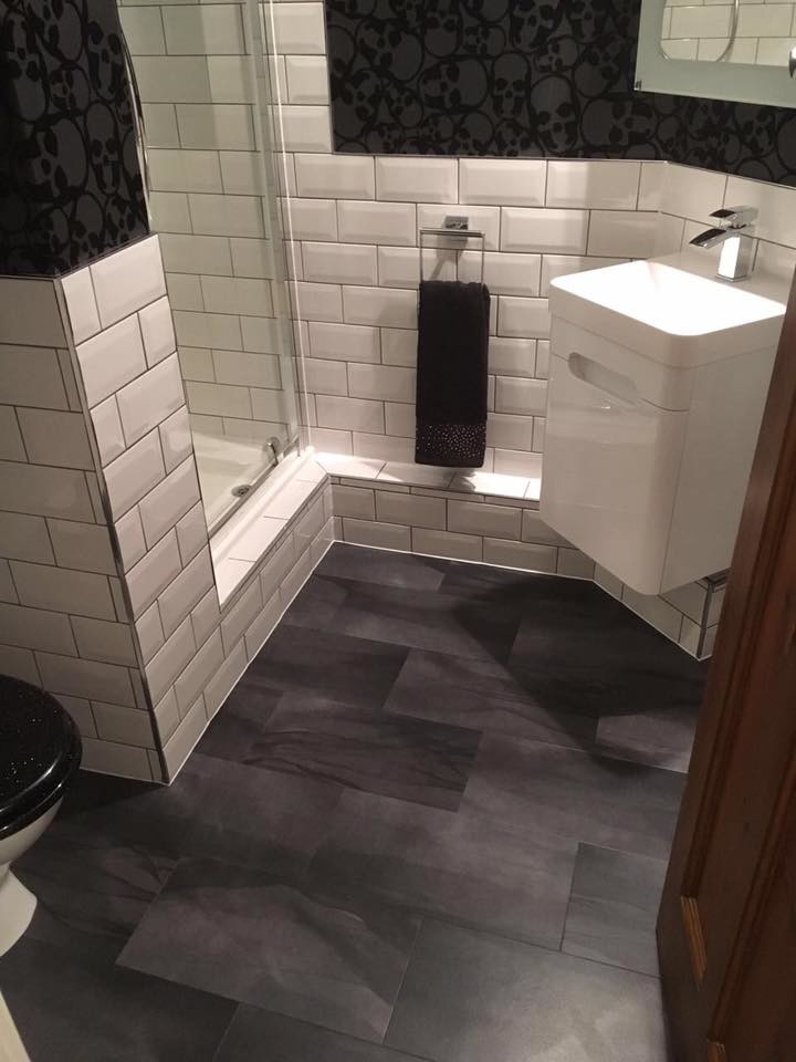Small contemporary 3/4 bathroom in San Francisco with flat-panel cabinets, white cabinets, a curbless shower, white tile, subway tile, black walls, vinyl floors, an integrated sink, brown floor, a hinged shower door and white benchtops.
