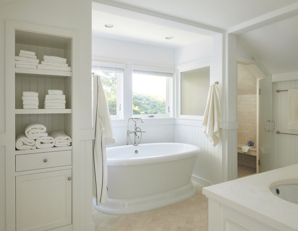 Design ideas for a beach style bathroom in Boston with a freestanding tub, an alcove shower, white walls, an undermount sink, beige floor and white benchtops.