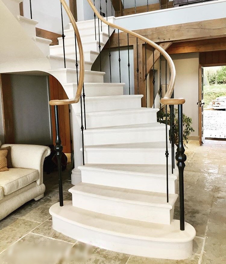Example of a large eclectic limestone floating metal railing staircase design in Other with limestone risers