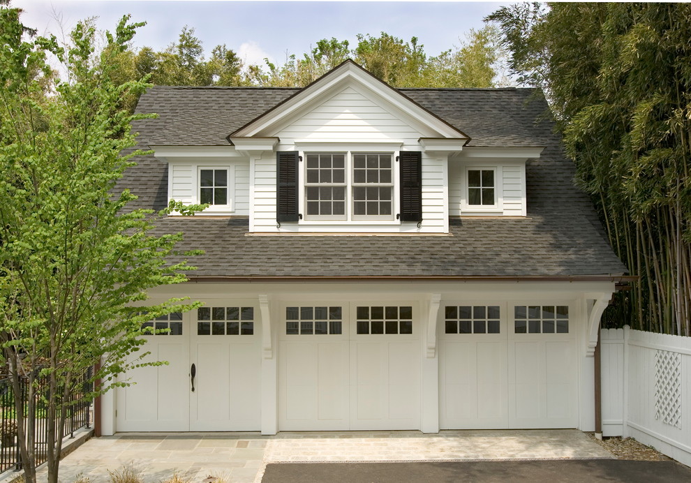 Photo of a traditional three-car garage in Other.