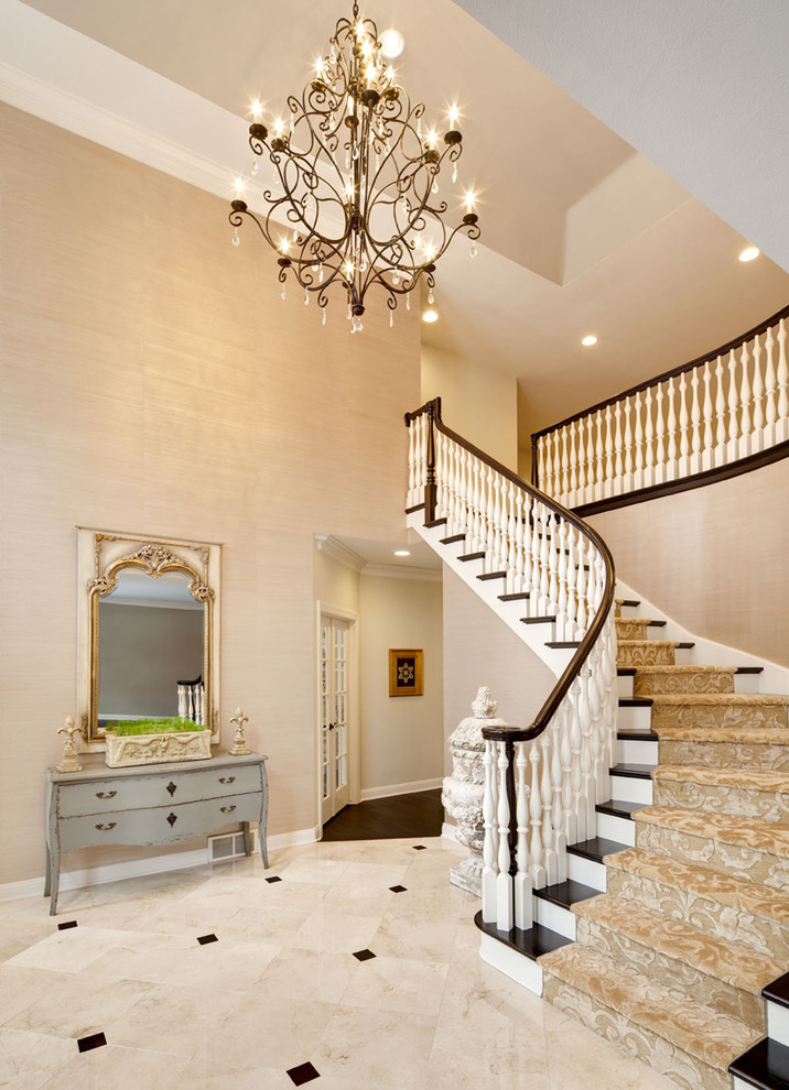 Design ideas for an expansive traditional foyer in Chicago with beige walls and marble floors.