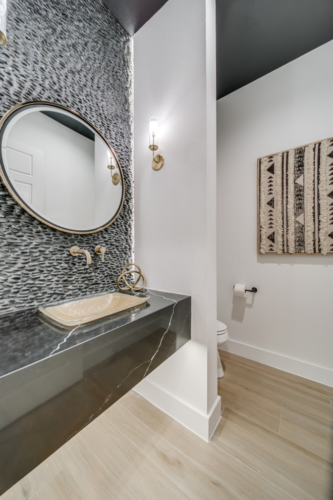 Example of a mid-century modern black tile porcelain tile powder room design in Dallas with black cabinets, a drop-in sink, quartz countertops, black countertops and a floating vanity