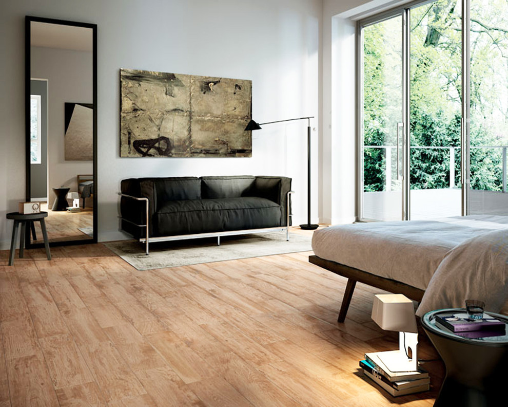 This is an example of a midcentury master bedroom in St Louis with porcelain floors.